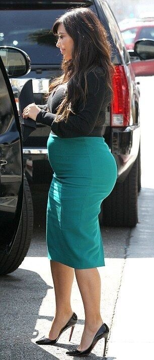 Kim Kardashian in a pencil skirt that shows her bulging tummy. Discover how to wear a pencil skirt if you have a belly.