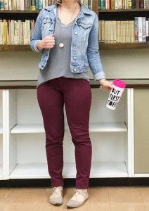 A lady in a gray top and burgundy pants