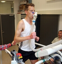 A man measuring his VO2 max, the measure of the milliliters of oxygen consumes in a minute per kilogram of body weight, as he runs on a treadmill