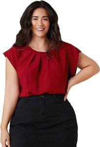 A well endowed lady wearing the Milumia Women's Plus Size Pleated Top Crew Neck Cap Sleeve Office Work Blouse