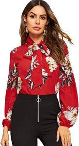 A lady show casing the Floerns Women's Floral Print Bow Tied Neck Lantern Long Sleeve Blouse Top