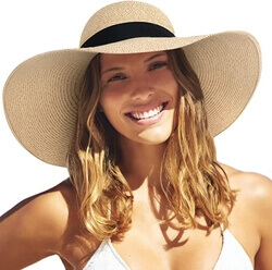 A happy lady wearing the Furtalk Women’s Wide Brim UPF 50 Summer Straw Hat
